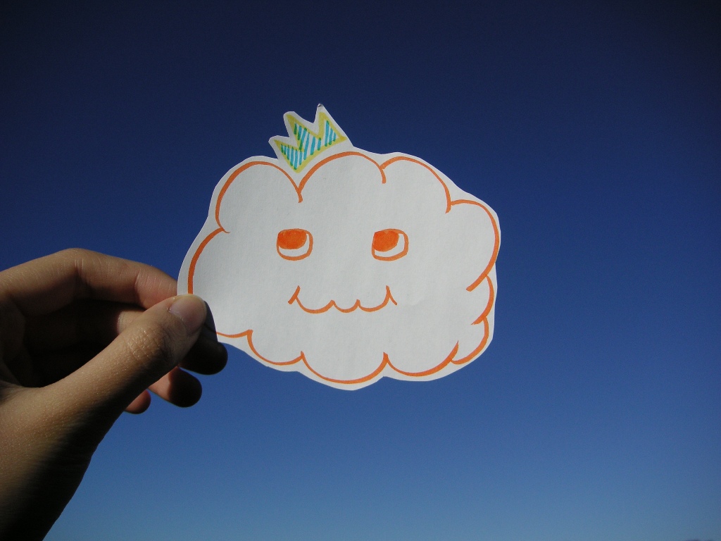Hand holding cloud cut out with crown