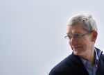 Apple CEO Tim Cook smiles and looks to the left.