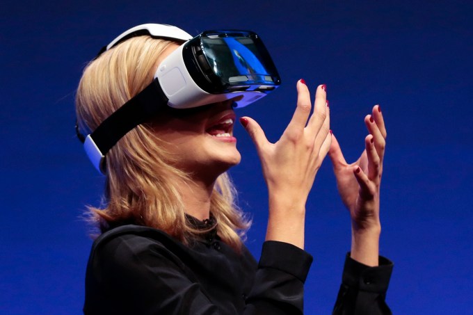 British television presenter Rachel Riley shows a virtual-reality headset called Gear VR during an unpacked event of Samsung ahead of the consumer electronic fair IFA in Berlin, Wednesday, Sept. 3, 2014. (AP Photo/Markus Schreiber)