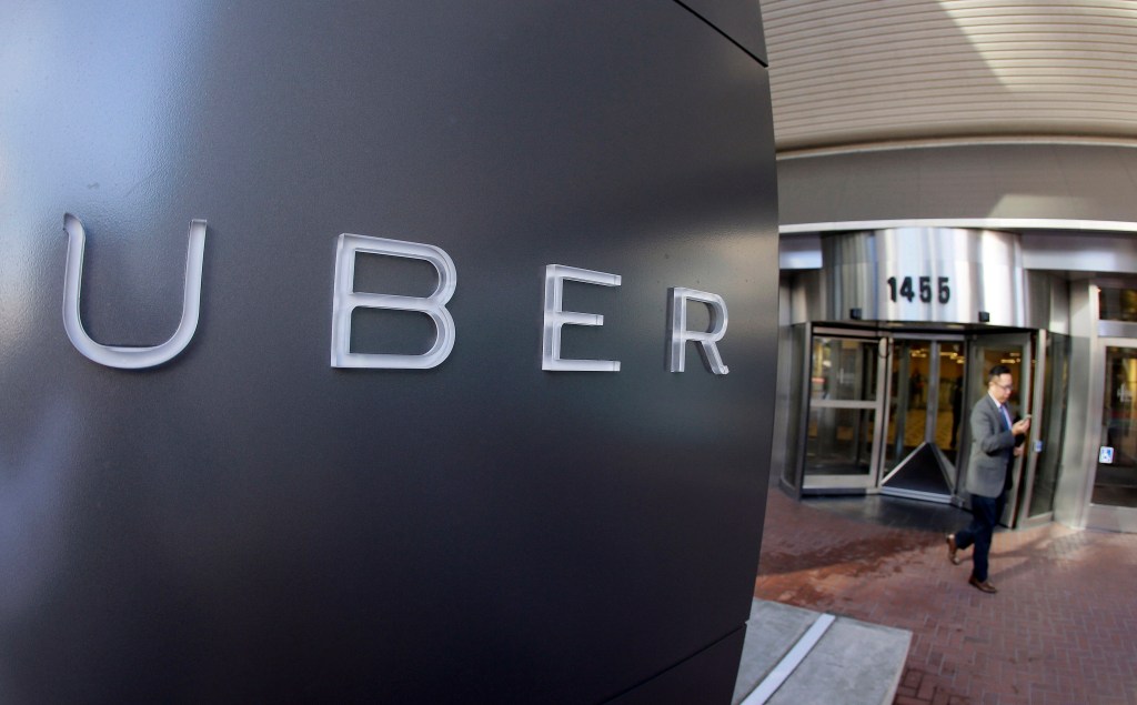In this Dec. 16, 2015 file photo a man leaves the headquarters of Uber in San Francisco