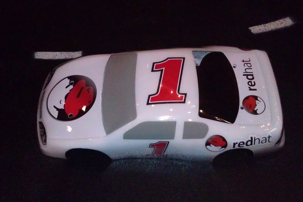 Red Hat race car with #1 painted on top.