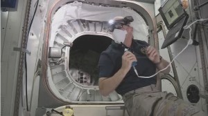 NASA Astronaut Jeff Williams floating outside the entrance to the Bigelow Expandable Activity Module (BEAM)