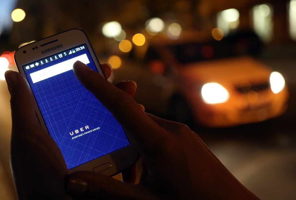 a woman uses the Uber app on an Samsung smartphone
