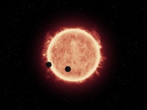 Artist illustration of two of the three planets in this system orbiting their star, which is smaller and cooler than our own sun / Image courtesy of NASA/ESA/STScI/J. de Wit