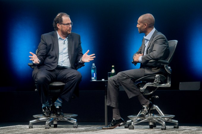 Marc Benioff, chairman and chief executive officer of Salesforce.com Inc., left, speaks with Tony Prophet, vice president of Windows marketing at Microsoft Corp., during the DreamForce Conference in San Francisco, California, U.S., on Monday, Oct. 13, 2014. Salesforce.com Inc. is entering a new business, data analytics and business intelligence, seeking to maintain growth and persuade customers to pour more of their information into its data centers. Photographer: Noah Berger/Bloomberg via Getty Images
