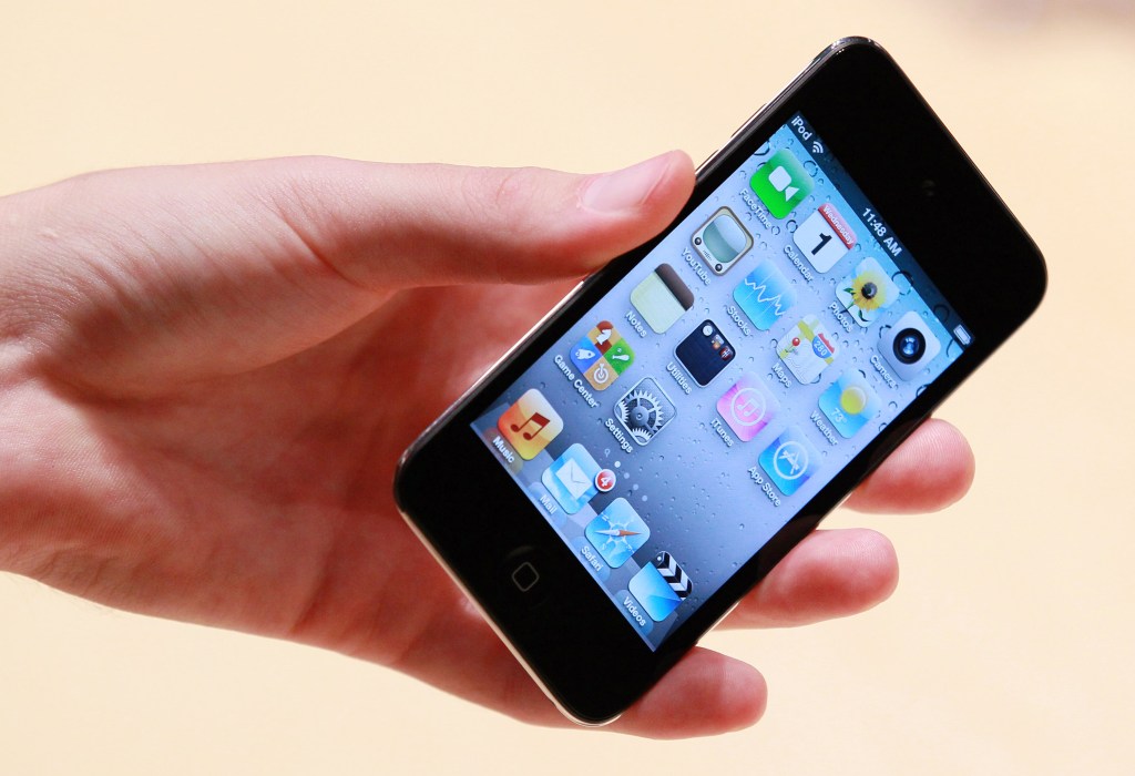An Apple employee holds a new iPod Touch