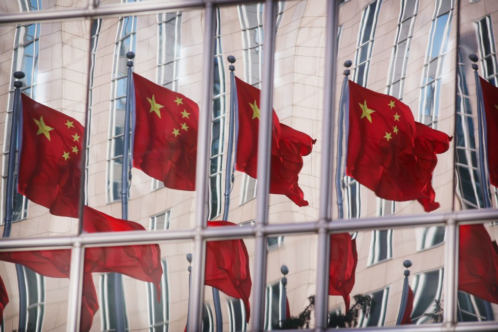 Chinese Flags Reflected In Office Skyscraper Windows