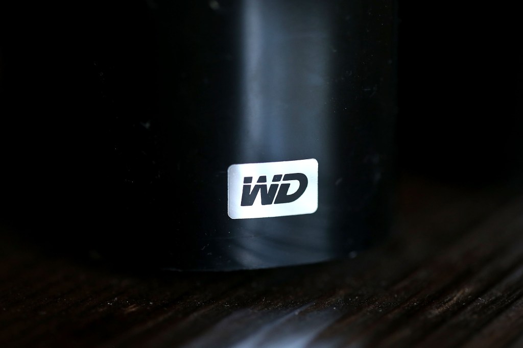 photo illustration, the Western Digital logo is displayed on an external hard drive