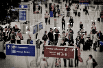A GIF of a facial recognition system matching faces in a busy airport.