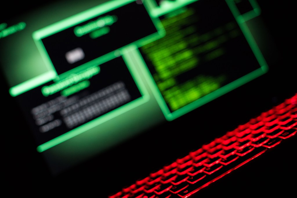 A fictional hacker software downloads data the monitor.