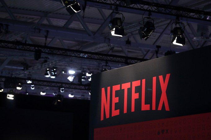 A Netflix Inc. logo sits on the online television streaming company's exhibition area at the Gamescom gaming industry event in Cologne, Germany