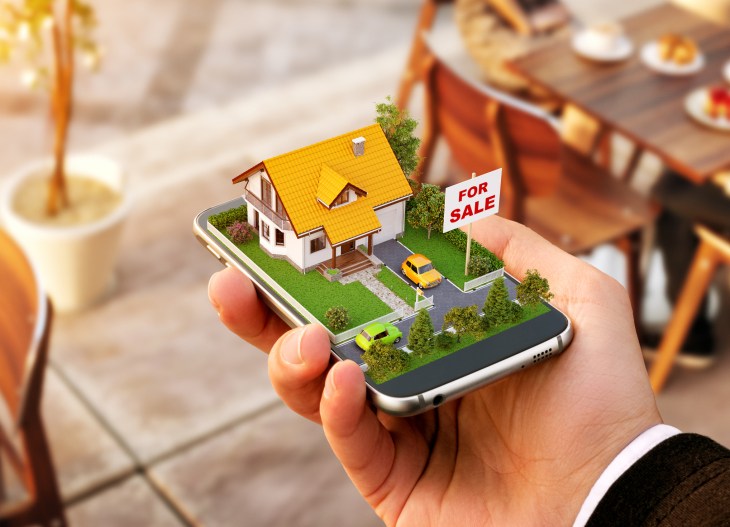 Smartphone application for online searching, buying, selling and booking real estate. Unusual 3D illustration of beautiful house on smart phone in hand