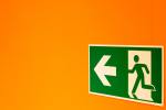 emergency exit sign on an orange wall