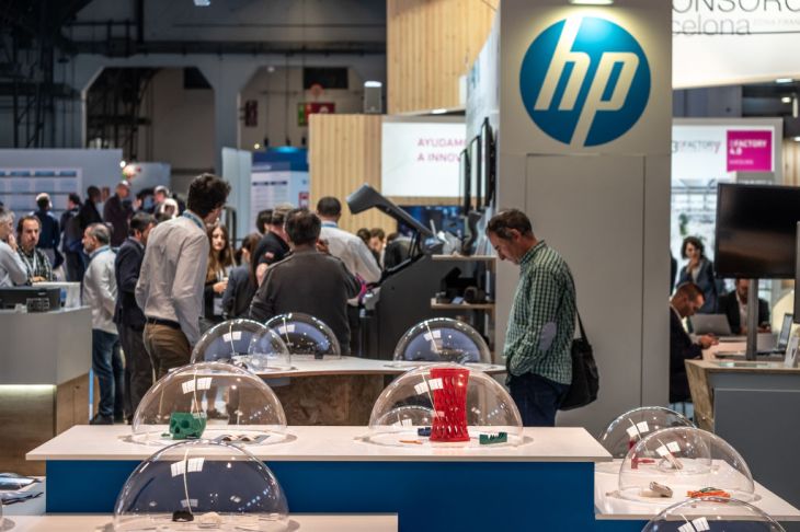 A man is seen admiring 3D models made with HP printers