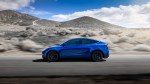 Blue Tesla Model Y sideview on desolate highway