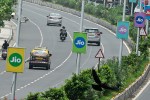 Traffic pass by advertising boards of Reliance Jio