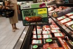 Impossible Foods Inc. signage is displayed during the company's grocery store product launch in Los Angeles, California, U.S., on Friday, Sept. 20, 2019. The Impossible Burger made its retail debut at 27 Gelson's Markets locations in Southern California before expanding its retail presence in the fourth quarter and in early 2020, the company said in a statement. Photographer: Patrick T. Fallon/Bloomberg