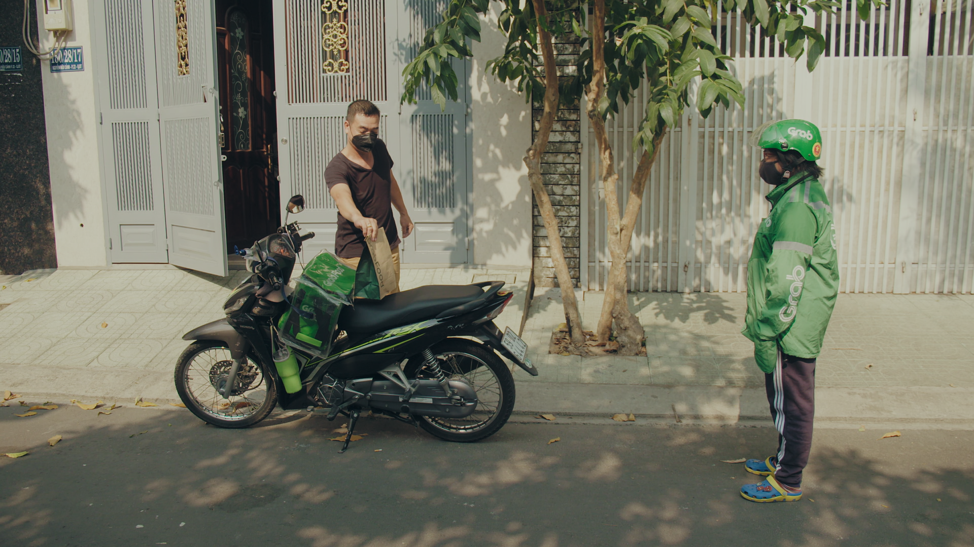A contactless delivery performed by a Grab delivery driver