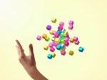 Colorful cubes forming geometric shapes with girls hands