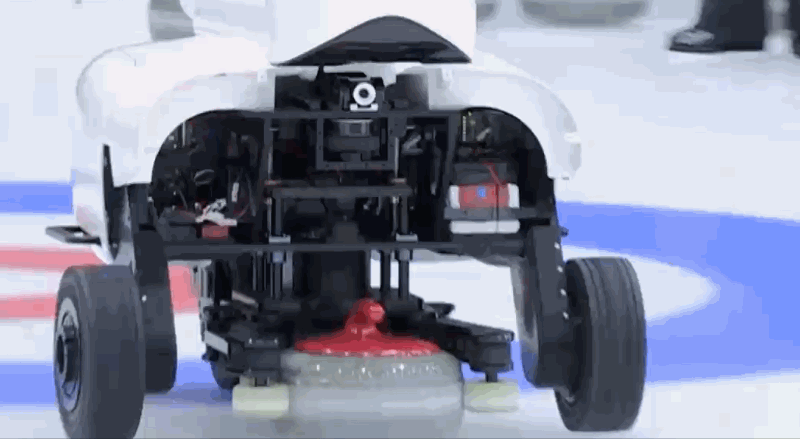 GIF image of Curly the curling robot releasing a stone.