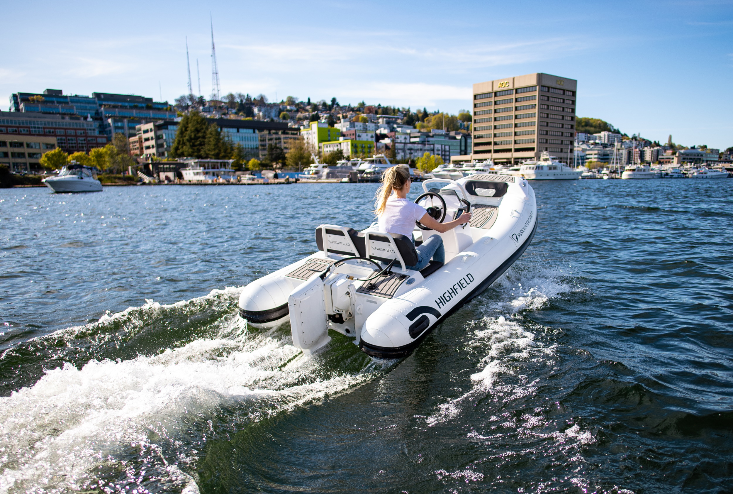 A boat with an electric outboard motor cruising on a lake.