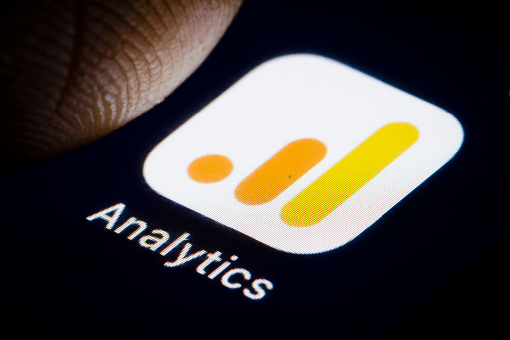 Photo illustration of the logo of freemium web analytics service Google Analytics is displayed on a smartphone.
