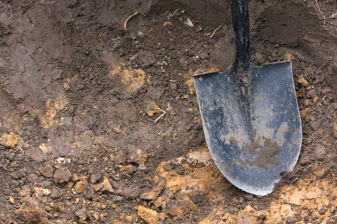 Close up of the spade shovel that is used to dig a hole in the ground