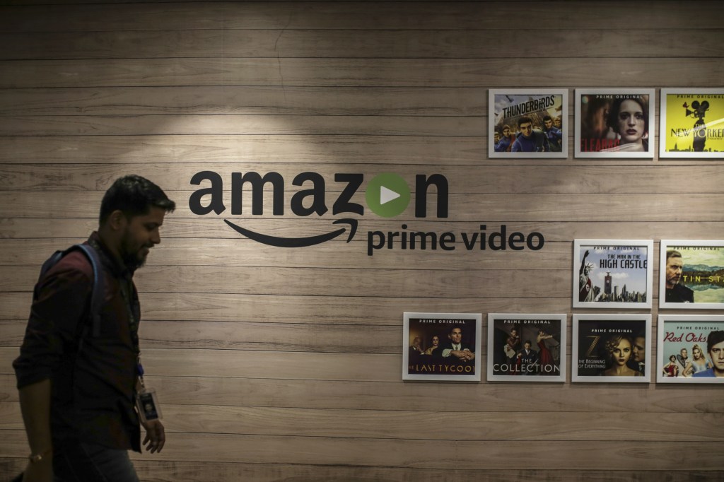 An employee walks past a wall display for Amazon.com Inc.'s Prime Video streaming service at the company's office campus in Hyderabad, India