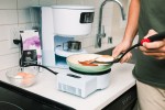 A home cook preparing food on Takumi's high induction cooktop. Yakumi is a smart home cooking appliance created by Yo-Kai Express.