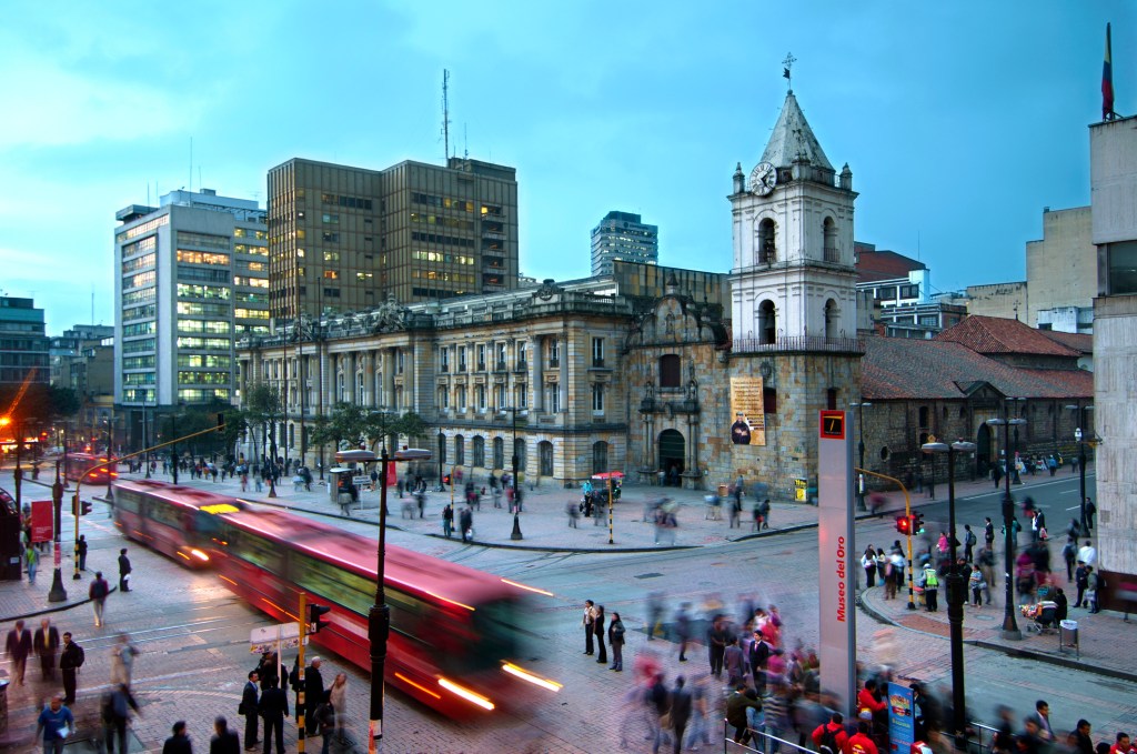 At the intersections of Avendia Jimenez and Carrera Septima, red Transmilenio buses pull into the Museum of Gold station in front of the16th century Iglesia de San Francisco, Bogota's oldest restored church.