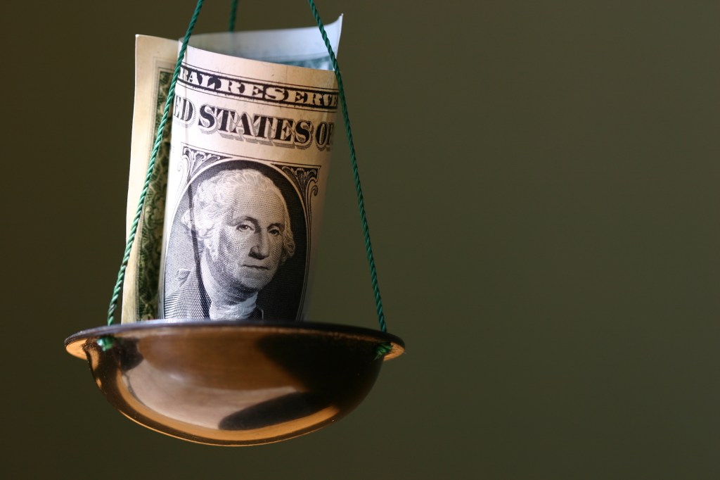 Dollar in a bowl of balance.