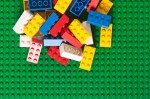 Pile of Lego Block Bricks on Green Baseplate