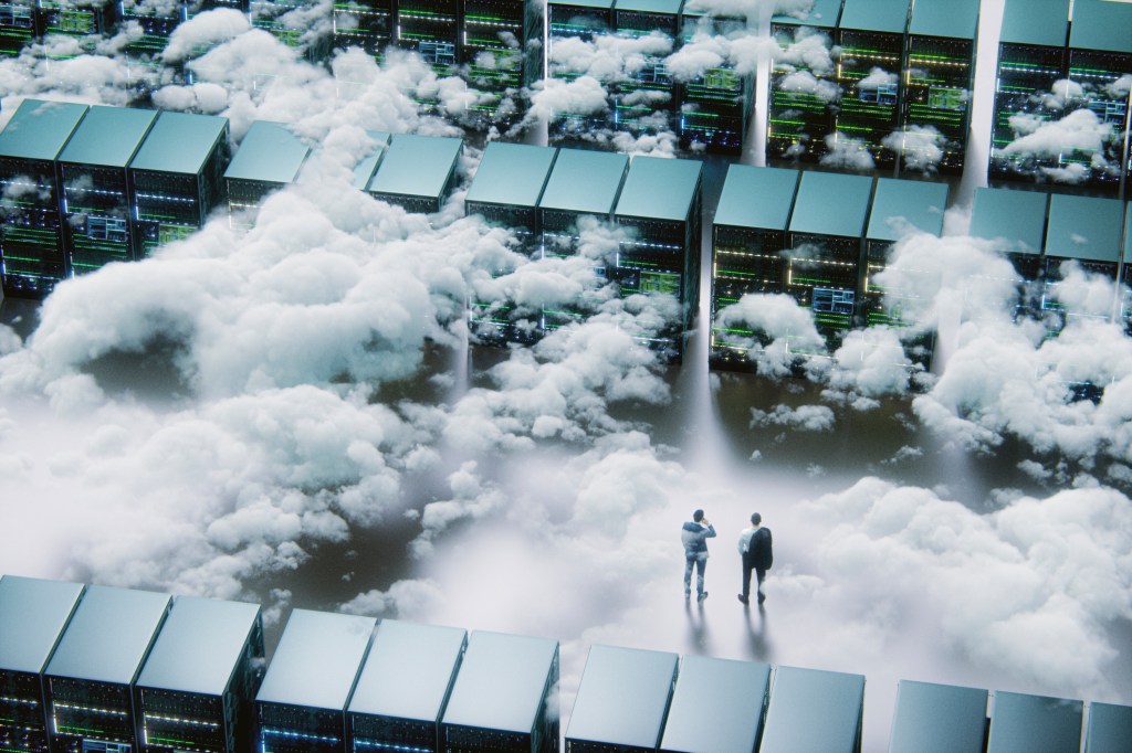 Two people stand inside a data center in the clouds. Shot from above looking down.
