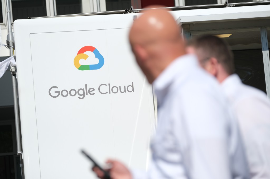 People walk past a Google Cloud exhibit during the press days at the 2019 IAA Frankfurt Auto Show