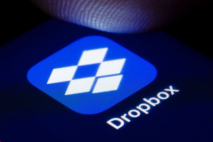 The logo of the file hosting service Dropbox is shown on the display of a smartphone