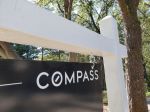 Close-up of a Compass Real Estate hanging sign panel in a wooded area, Lafayette, California, October 21, 2020. (Photo by Smith Collection/Gado/Getty Images)