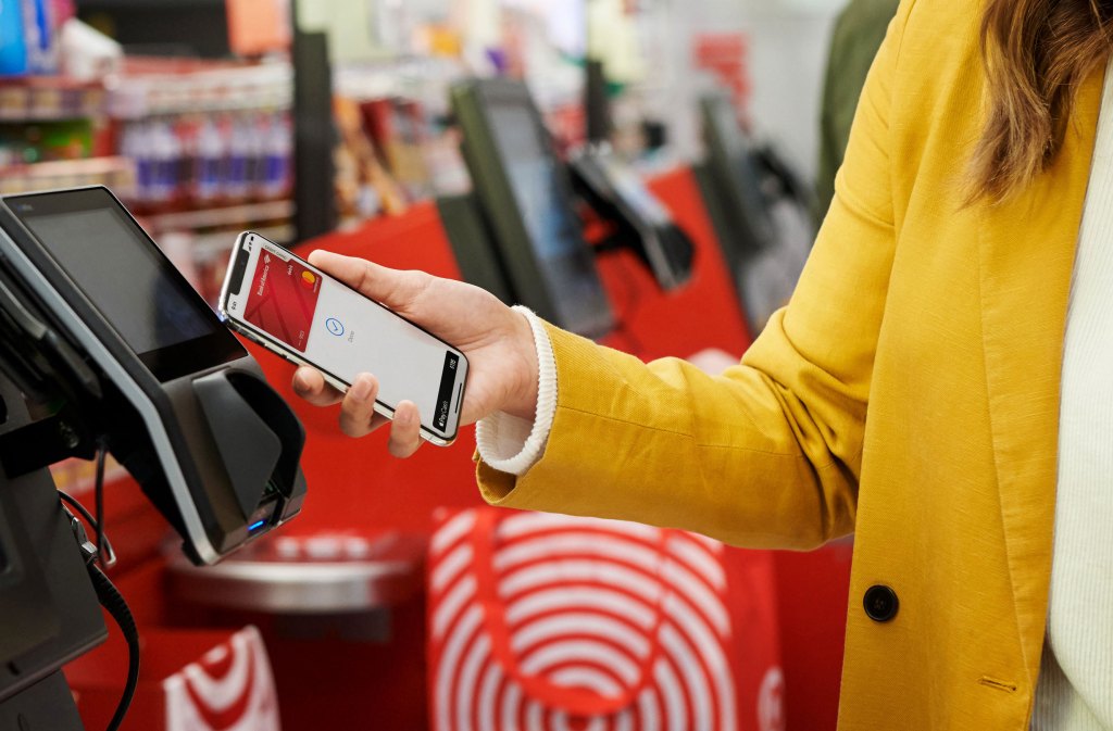 Person checking out at a store using Apple Pay