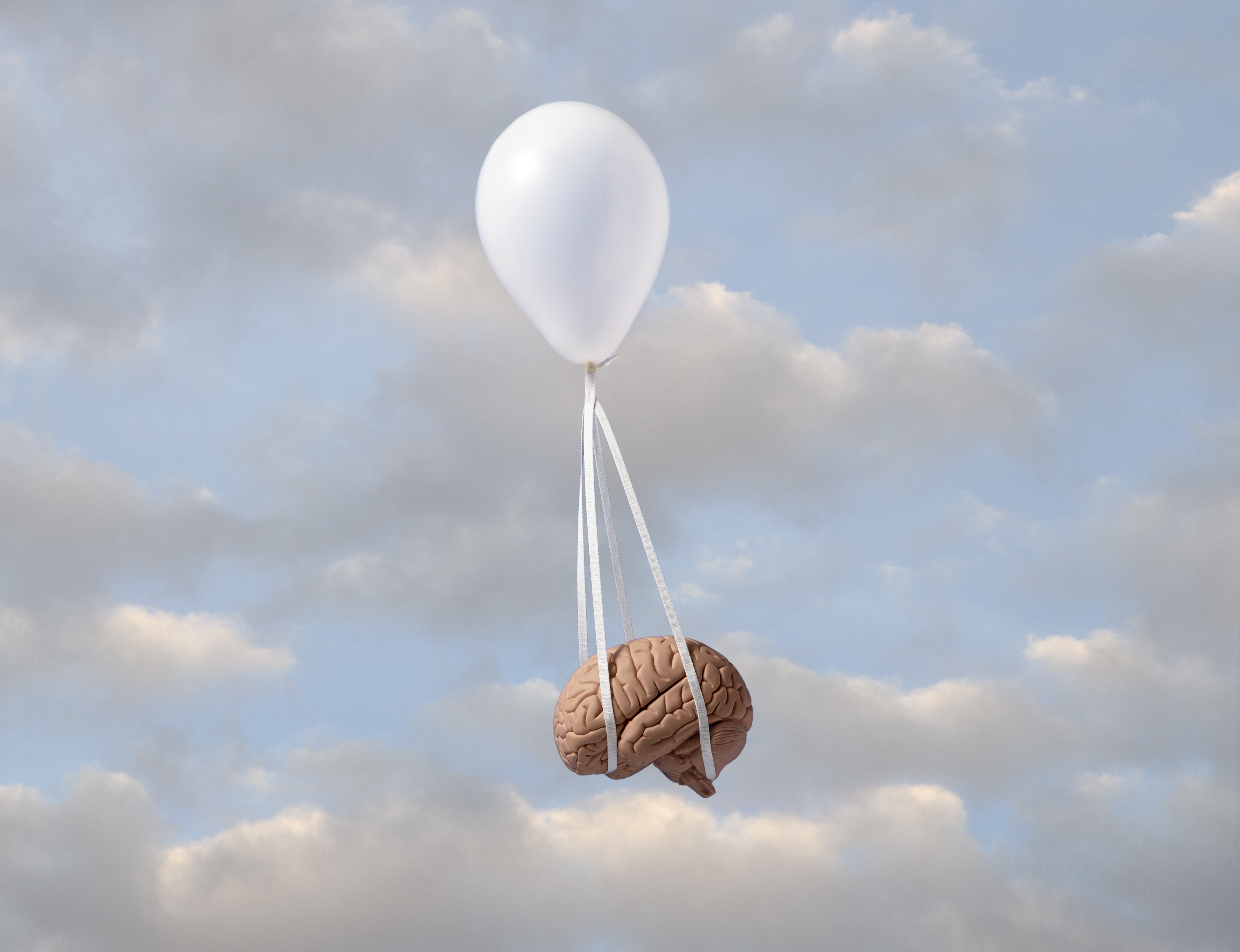 Image of a balloon carrying away a brain.