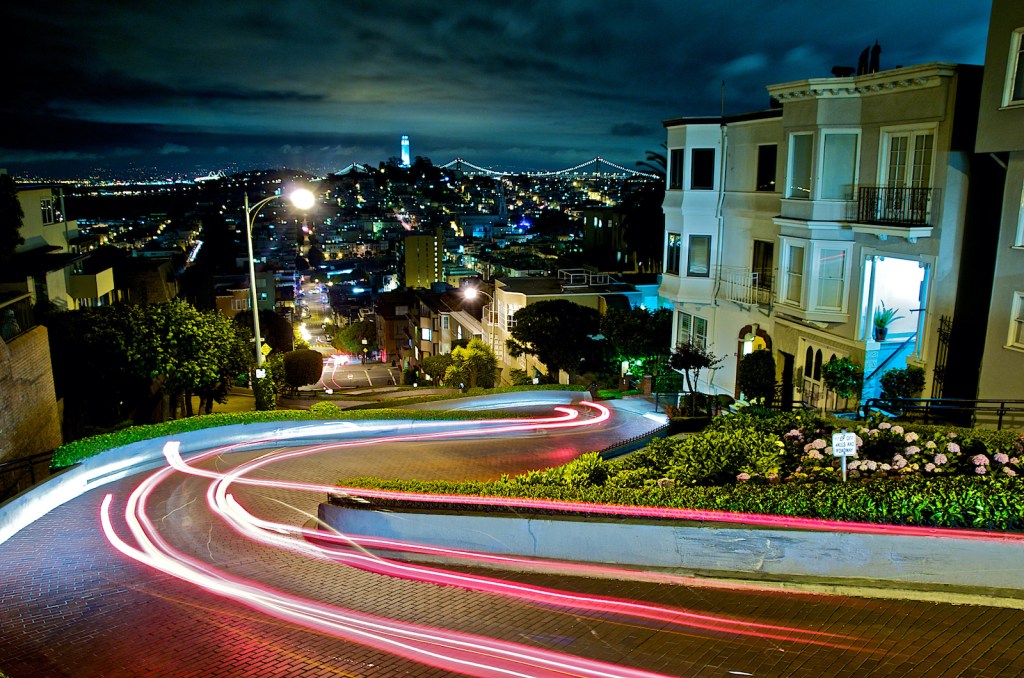 Long exposure night shot of vehicle tail lights taken on Lombard Street in San Francisco.