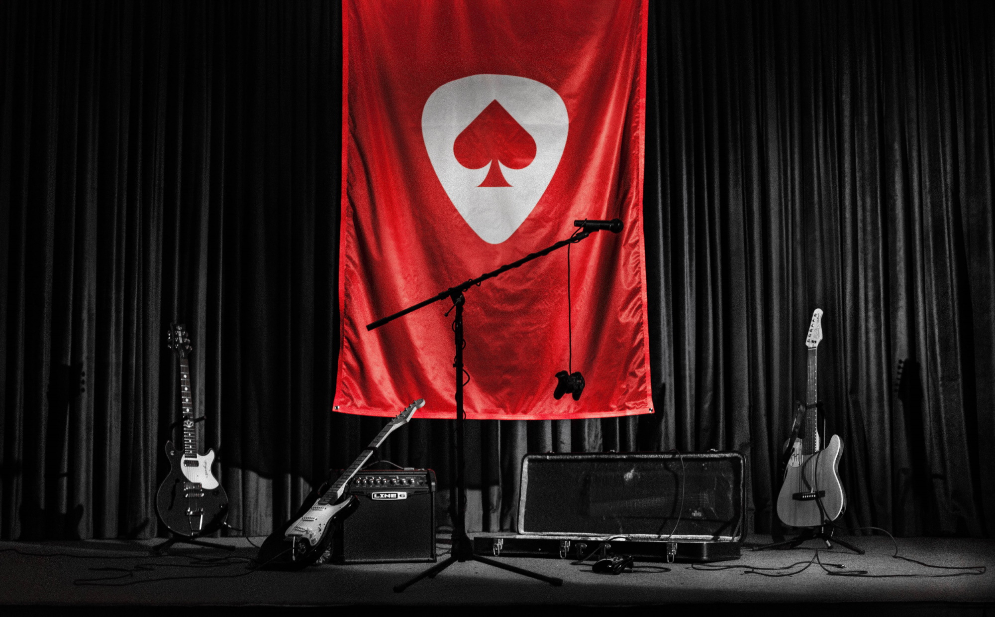 The Game Band logo on a flag behind several instruments.