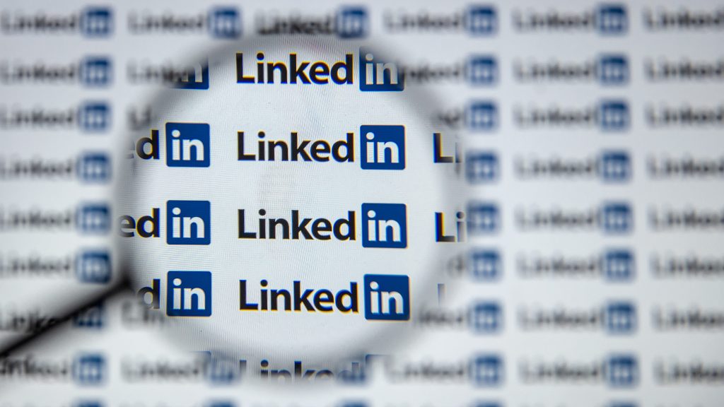 photo illustration a screen displays LinkedIn logo