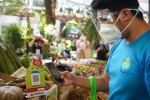 A man uses financial services app PayMaya to make a payment at a produce stand in the Philippines