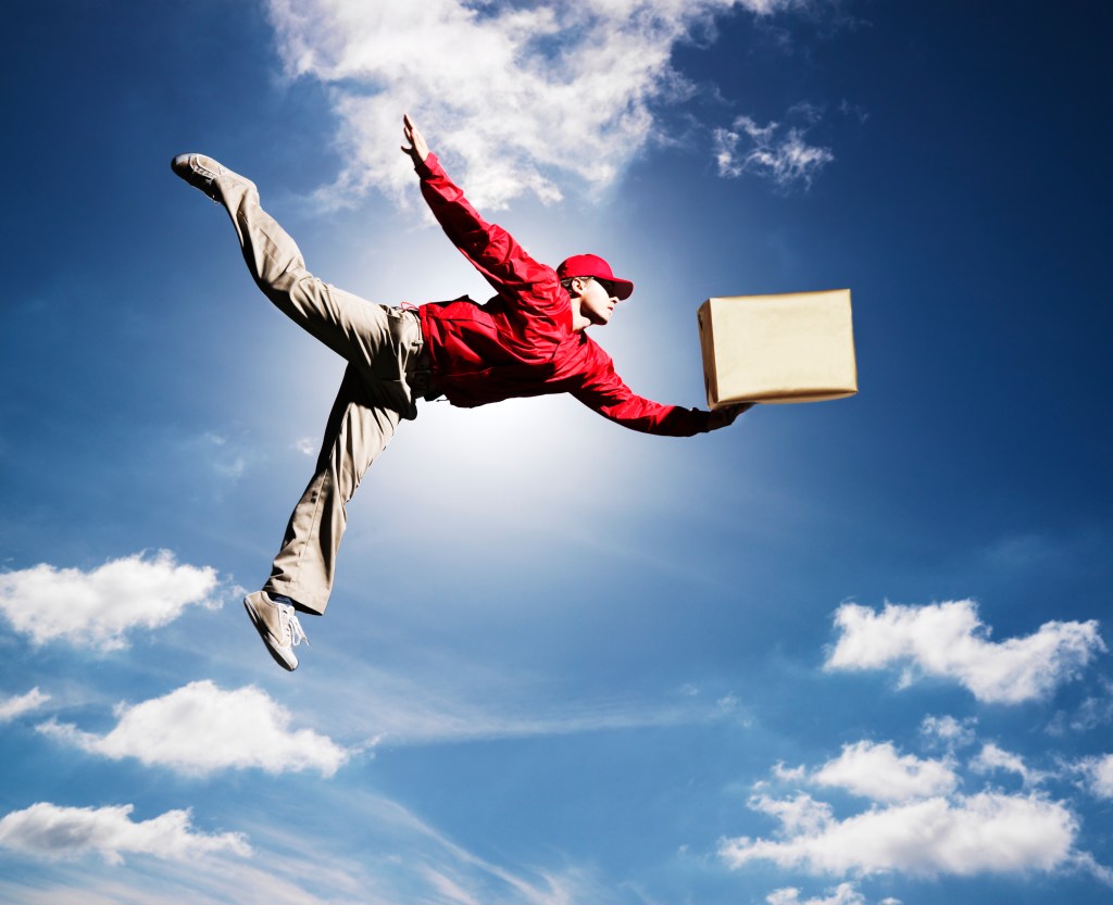 Image of a man flying in the sky holding a box to represent speedy deliveries.