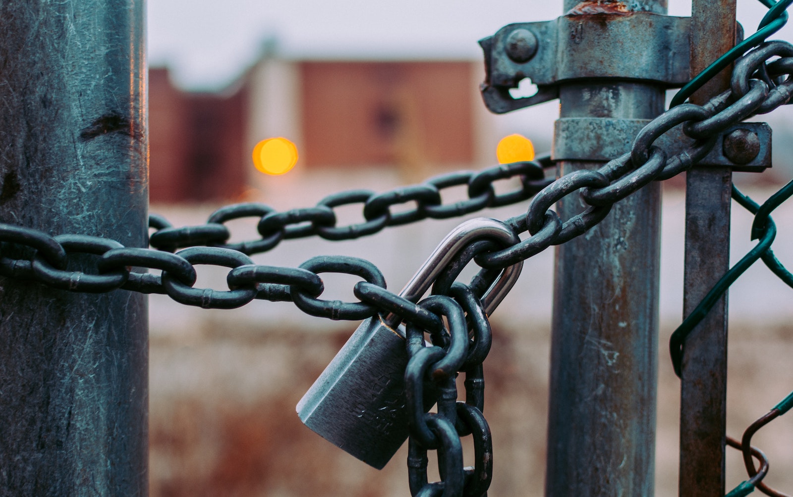 A padlocked chain keeps a fence or gate closed