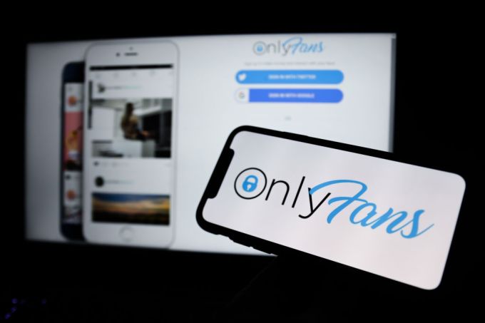 OnlyFans logo displayed on a phone screen and a website