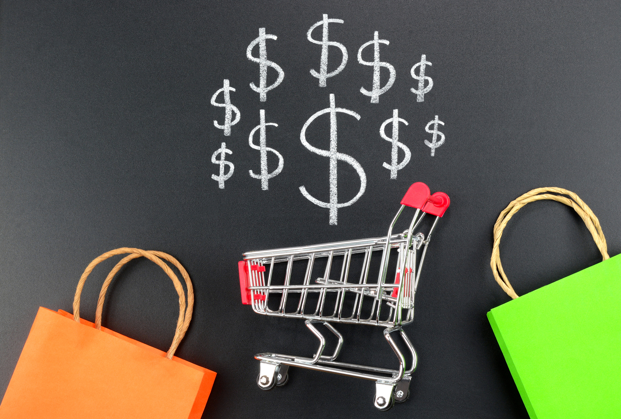 Shopping cart with dollar sign and colorful shopping bags.