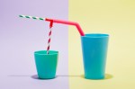 A combination of drinking straws in two cups