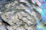 US quarter photographed through a prism, creating a multiple exposure effect focused on George Washington’s face