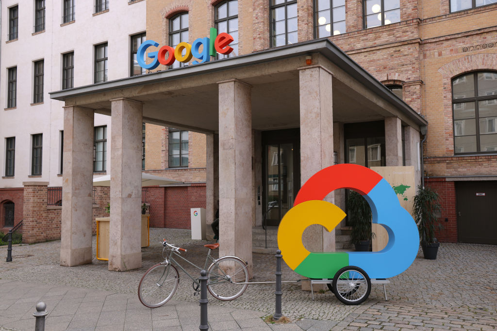 Google's corporate logo and the Google Cloud logo stand outside the Google Germany offices in Berlin.