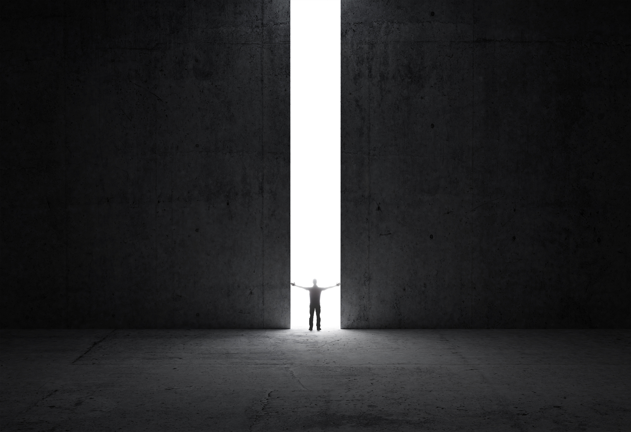 Man stands in the light of a large doorway